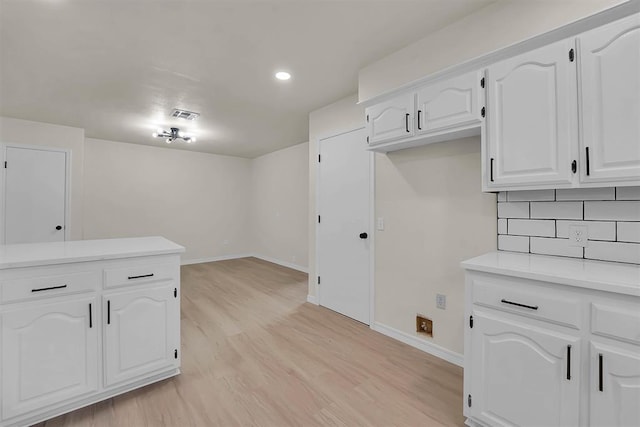 1712 N 4th St, Sayre, OK 73662 - kitchen with light wood-style flooring, white cabinetry, light countertops, and recessed lighting