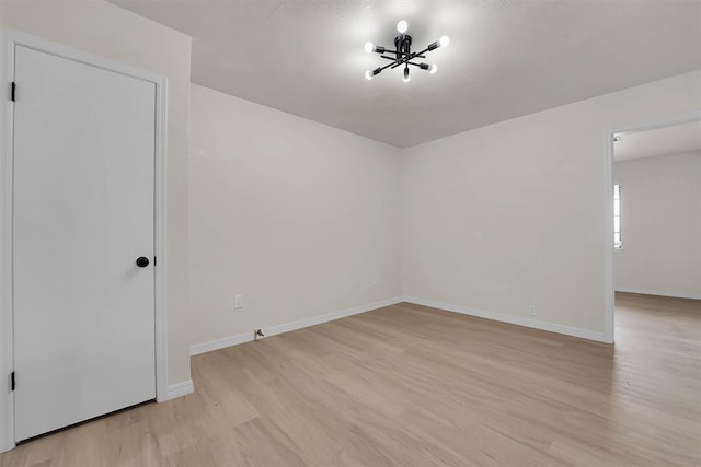 1712 N 4th St, Sayre, OK 73662 - empty room featuring light wood-style flooring and a chandelier