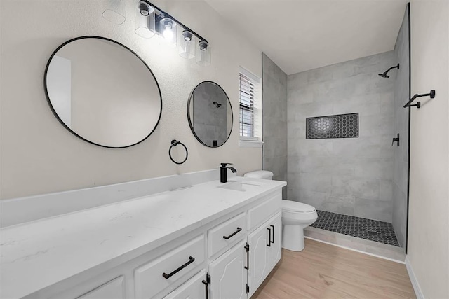 1712 N 4th St, Sayre, OK 73662 - bathroom with vanity, tiled shower, and wood finished floors