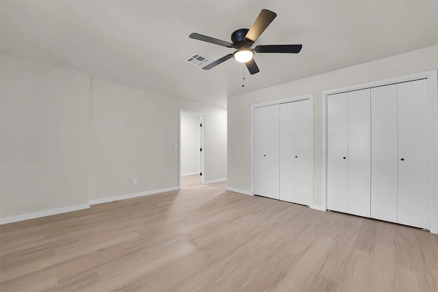 1712 N 4th St, Sayre, OK 73662 - unfurnished bedroom with two closets, light wood-style flooring, and a ceiling fan
