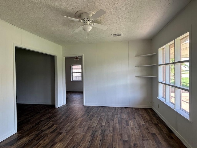 1708 W Modelle Ave, Clinton, OK 73601 - empty room featuring dark wood finished floors, a textured ceiling, and ceiling fan