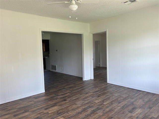 1708 W Modelle Ave, Clinton, OK 73601 - spare room featuring dark wood-style floors, ceiling fan, and a textured ceiling
