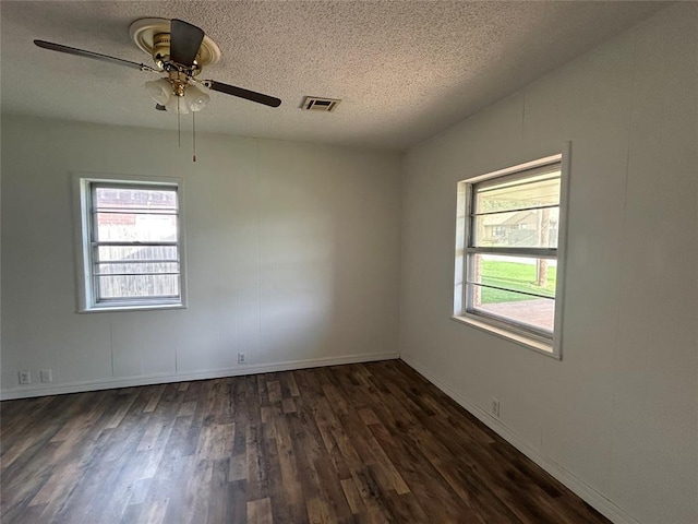 1708 W Modelle Ave, Clinton, OK 73601 - spare room with a textured ceiling, dark wood finished floors, and a ceiling fan