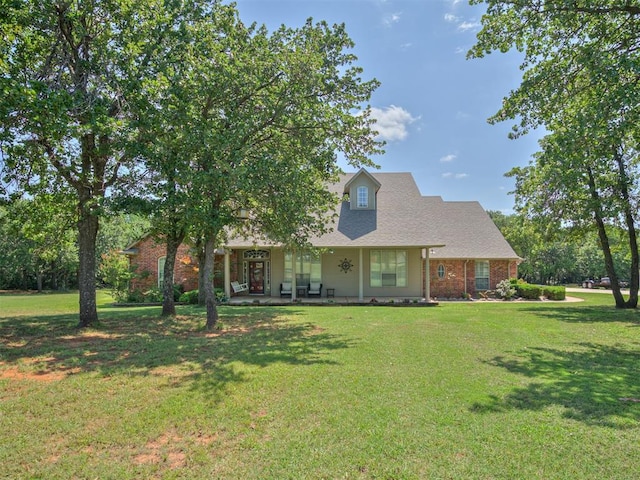 1810 Sandpiper Dr, Blanchard, OK 73010 - cape cod home with a front lawn, brick siding, and covered porch