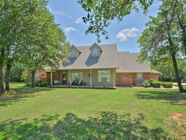 1810 Sandpiper Dr, Blanchard, OK 73010 - view of front of home with a front lawn, a porch, a shingled roof, and brick siding