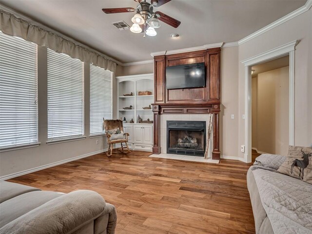1810 Sandpiper Dr, Blanchard, OK 73010 - living area featuring ceiling fan, a fireplace, light wood-style flooring, and ornamental molding