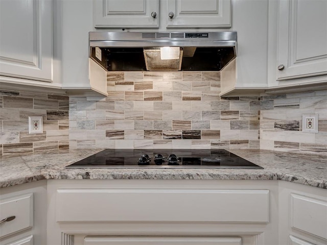 1810 Sandpiper Dr, Blanchard, OK 73010 - kitchen with range hood, black electric cooktop, white cabinetry, and decorative backsplash