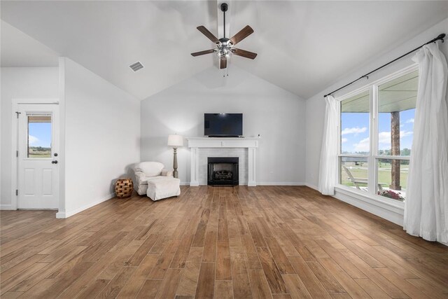2326 County Road 1335, Blanchard, OK 73010 - unfurnished living room featuring ceiling fan, wood finished floors, a fireplace, and vaulted ceiling