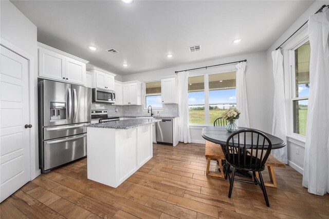 2326 County Road 1335, Blanchard, OK 73010 - kitchen with stainless steel appliances, white cabinetry, a kitchen island, dark wood-style flooring, and recessed lighting