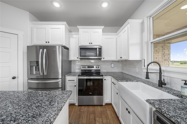 2326 County Road 1335, Blanchard, OK 73010 - kitchen with appliances with stainless steel finishes, white cabinets, dark stone counters, and recessed lighting