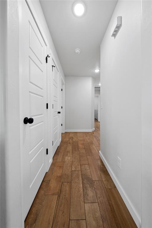 2326 County Road 1335, Blanchard, OK 73010 - hall with dark wood-type flooring and baseboards