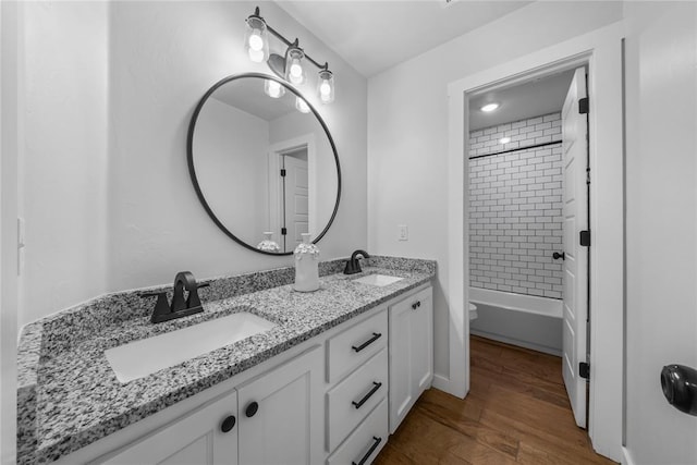 2326 County Road 1335, Blanchard, OK 73010 - full bath with double vanity, wood finished floors, and shower / bathtub combination