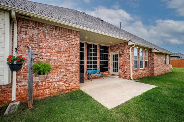 1865 Buckskin Ct, Blanchard, OK 73010 - back of property with brick siding, a patio, and roof with shingles
