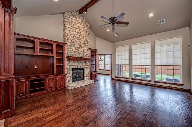 1865 Buckskin Ct, Blanchard, OK 73010 - unfurnished living room featuring a stone fireplace, beam ceiling, a ceiling fan, dark wood-style flooring, and high vaulted ceiling