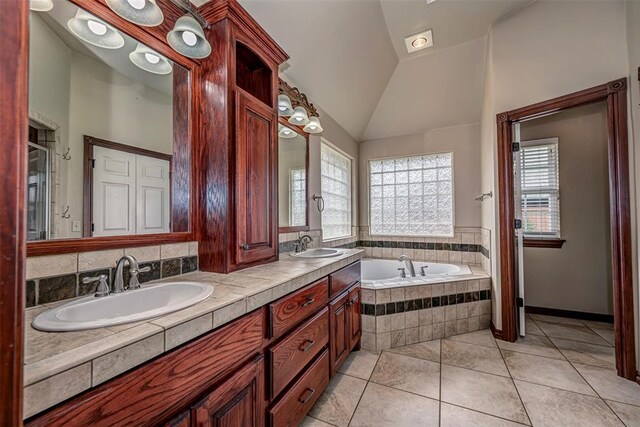 1865 Buckskin Ct, Blanchard, OK 73010 - full bathroom featuring a bath, double vanity, vaulted ceiling, and tile patterned flooring