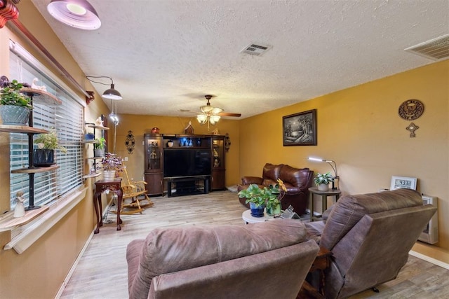 349760 E 970th Rd, Sparks, OK 74869 - living room featuring a textured ceiling, a ceiling fan, and wood finished floors