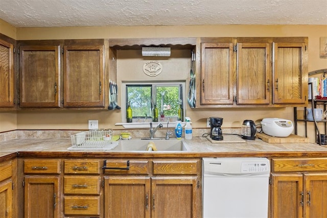 349760 E 970th Rd, Sparks, OK 74869 - kitchen with dishwasher, a textured ceiling, light countertops, and brown cabinetry