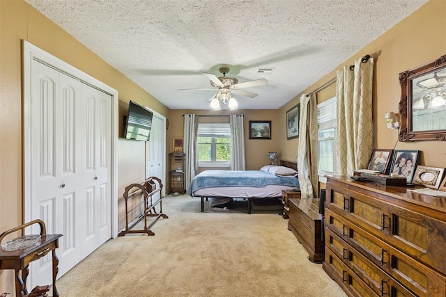 349760 E 970th Rd, Sparks, OK 74869 - bedroom featuring carpet flooring, a textured ceiling, a ceiling fan, and multiple closets