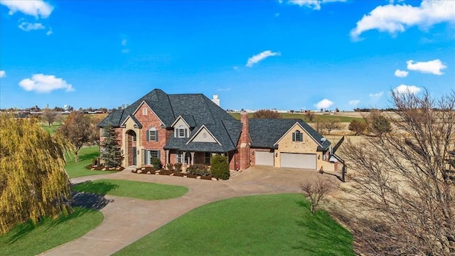 108 E Stroh Ave, Okarche, OK 73762 - view of front of home with curved driveway, a chimney, a front lawn, a garage, and stone siding