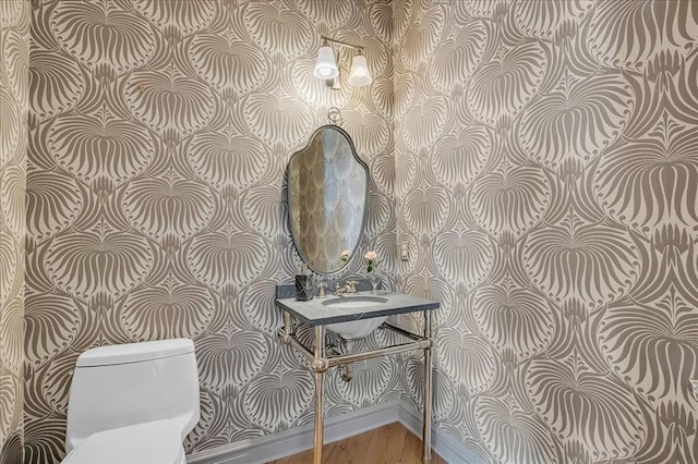 108 E Stroh Ave, Okarche, OK 73762 - bathroom featuring wallpapered walls and wood finished floors