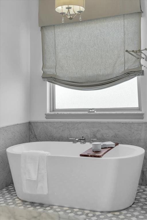 108 E Stroh Ave, Okarche, OK 73762 - full bathroom with a soaking tub, tile walls, and wainscoting