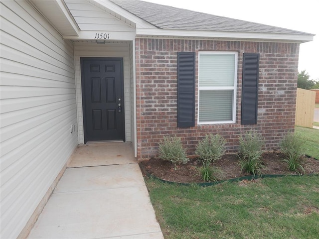 11501 Ruger Rd, Yukon, OK 73099 - property entrance with brick siding and roof with shingles