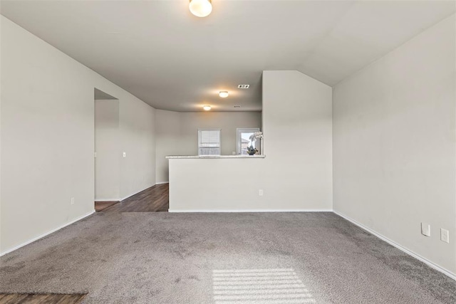 11501 Ruger Rd, Yukon, OK 73099 - unfurnished living room featuring dark colored carpet and baseboards