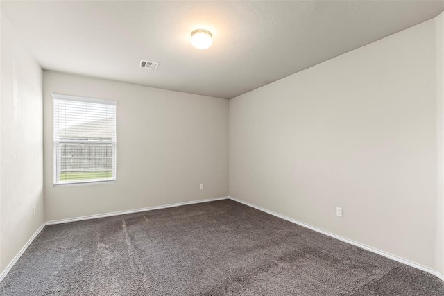 11501 Ruger Rd, Yukon, OK 73099 - empty room featuring dark carpet and baseboards