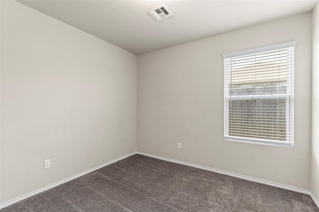 11501 Ruger Rd, Yukon, OK 73099 - empty room featuring dark colored carpet and baseboards
