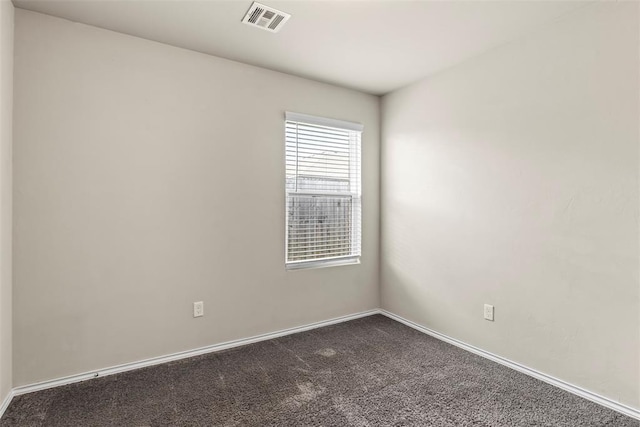 11501 Ruger Rd, Yukon, OK 73099 - empty room with dark carpet and baseboards
