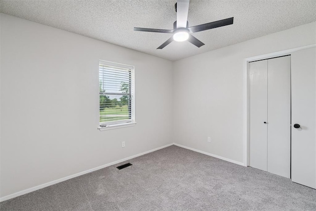 12073 N3540 Rd, Seminole, OK 74868 - unfurnished bedroom with a textured ceiling, carpet floors, a closet, and ceiling fan