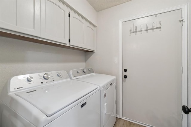 12073 N3540 Rd, Seminole, OK 74868 - laundry area featuring cabinet space, washer and dryer, and light wood-type flooring