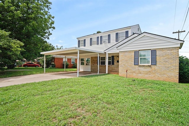 312 Jon St, Guthrie, OK 73044 - traditional home with brick siding, concrete driveway, a front yard, and a carport