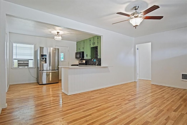312 Jon St, Guthrie, OK 73044 - kitchen with stainless steel appliances, green cabinets, light wood-style flooring, a peninsula, and light countertops