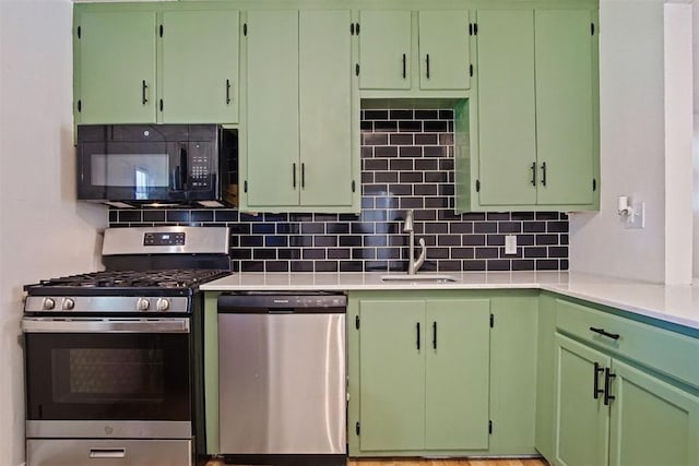 312 Jon St, Guthrie, OK 73044 - kitchen featuring stainless steel appliances, light countertops, and backsplash