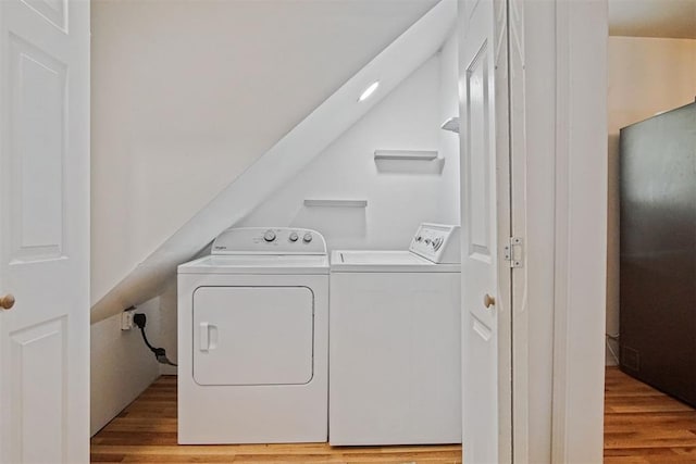 312 Jon St, Guthrie, OK 73044 - laundry area featuring washing machine and dryer and wood finished floors