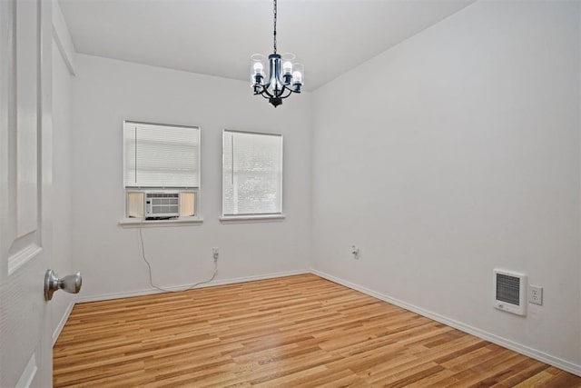 312 Jon St, Guthrie, OK 73044 - unfurnished room with a chandelier, light wood-style floors, cooling unit, and heating unit