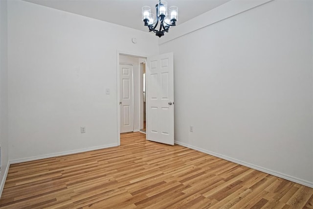 312 Jon St, Guthrie, OK 73044 - empty room with a chandelier and light wood finished floors