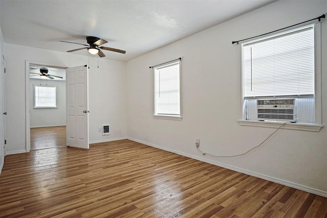 312 Jon St, Guthrie, OK 73044 - spare room featuring wood finished floors, a ceiling fan, and cooling unit