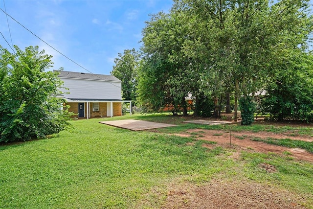 312 Jon St, Guthrie, OK 73044 - view of green lawn with a patio