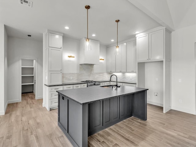1092 S Mustang Rd, Blanchard, OK 73010 - kitchen with light wood finished floors, white cabinets, stainless steel stove, and recessed lighting