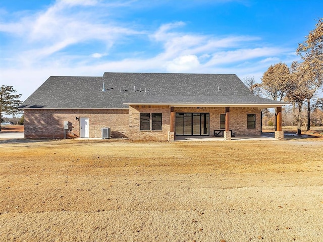 1092 S Mustang Rd, Blanchard, OK 73010 - back of house featuring brick siding, roof with shingles, and a patio