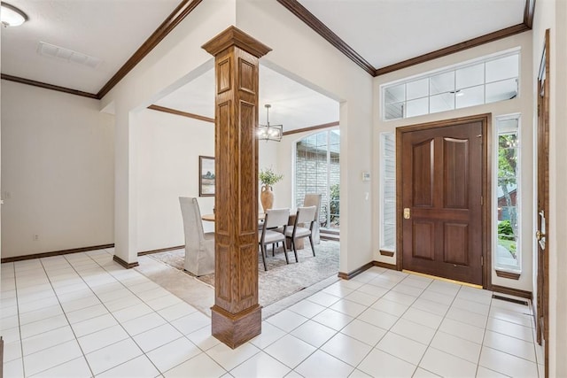 2717 Asheforde Oaks Blvd, Edmond, OK 73034 - foyer featuring ornamental molding, a chandelier, light tile patterned floors, and decorative columns