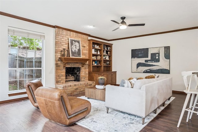 2717 Asheforde Oaks Blvd, Edmond, OK 73034 - living area with wood finished floors, ornamental molding, ceiling fan, and a fireplace