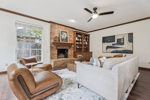 2717 Asheforde Oaks Blvd, Edmond, OK 73034 - living area featuring dark wood-style floors, ceiling fan, ornamental molding, and a fireplace