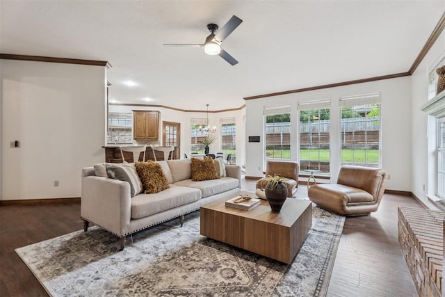 2717 Asheforde Oaks Blvd, Edmond, OK 73034 - living room featuring ornamental molding, a ceiling fan, dark wood-style flooring, and healthy amount of natural light