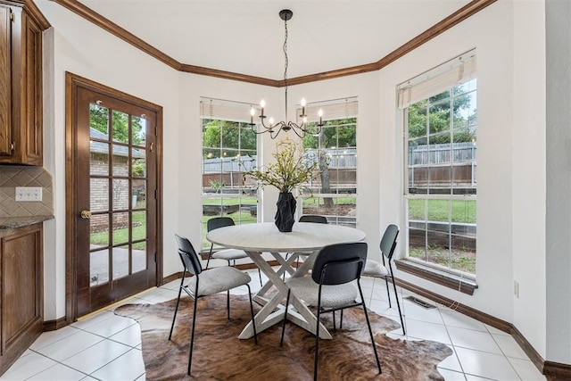 2717 Asheforde Oaks Blvd, Edmond, OK 73034 - dining space featuring crown molding, light tile patterned floors, and a chandelier