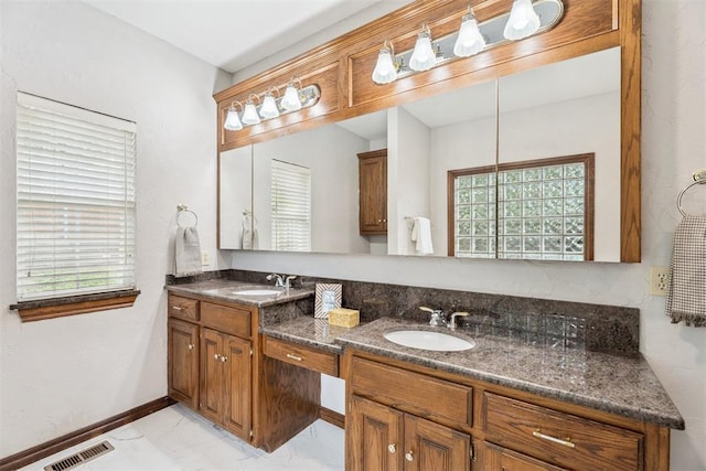 2717 Asheforde Oaks Blvd, Edmond, OK 73034 - full bath with double vanity, marble look tiles, and healthy amount of natural light
