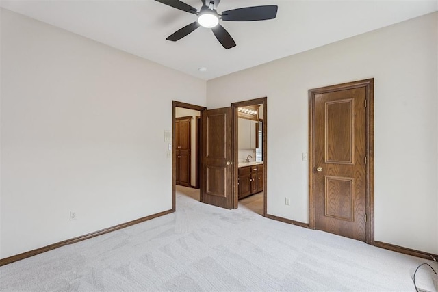 2717 Asheforde Oaks Blvd, Edmond, OK 73034 - unfurnished bedroom featuring light colored carpet, connected bathroom, and ceiling fan