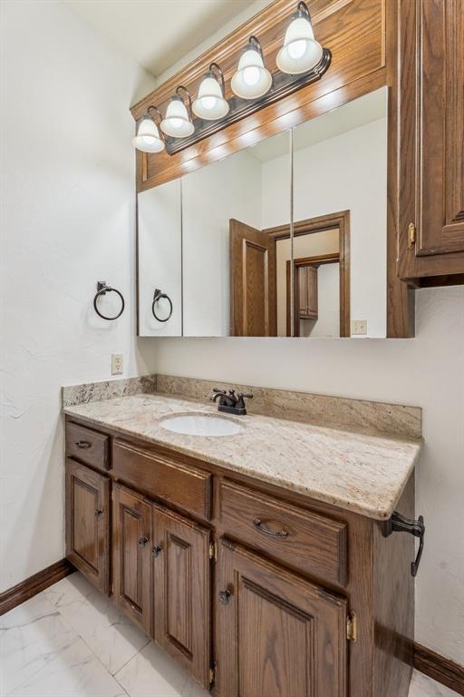 2717 Asheforde Oaks Blvd, Edmond, OK 73034 - bathroom with vanity and marble look tile flooring